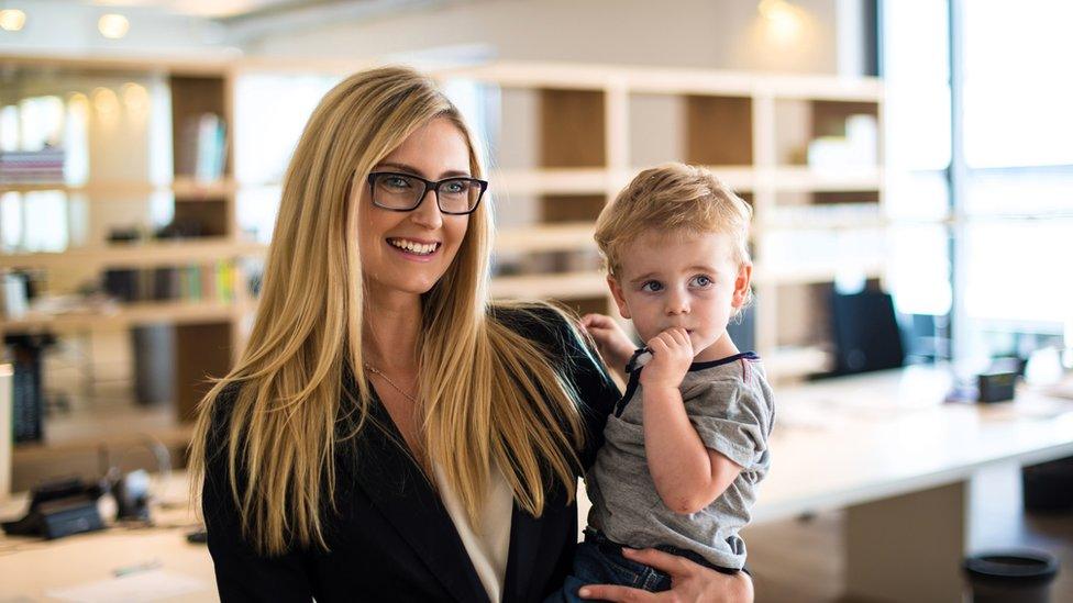 Woman with child in office