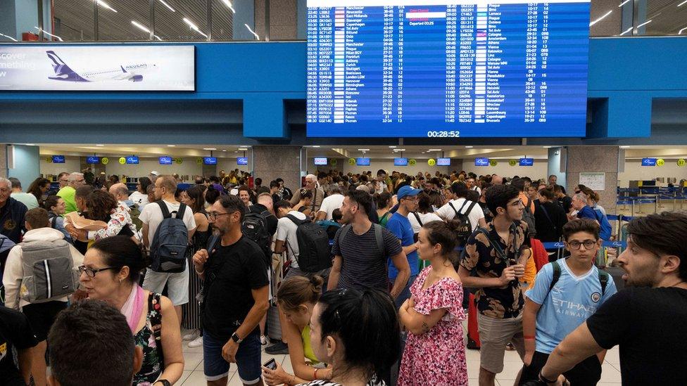 Tourists wait for departing planes at the airport