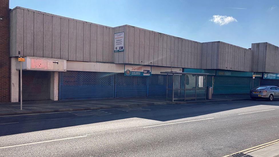 A view of empty single-storey shops on Osborne Street, Grimsby