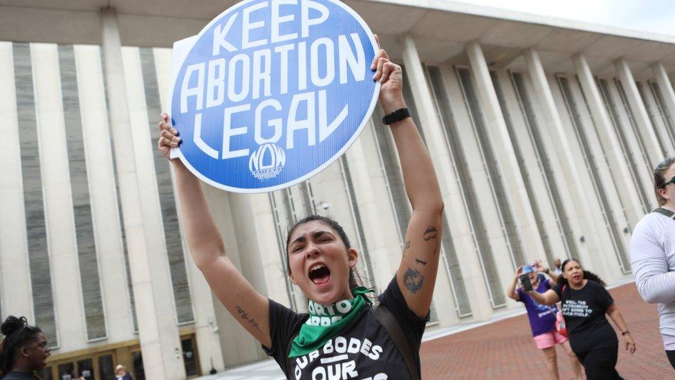 File image of a protester holding up a sign which reads: "Keep abortion legal"