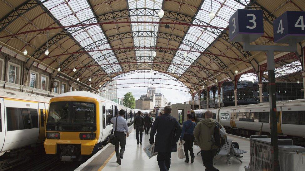 people running for a train at a london train station