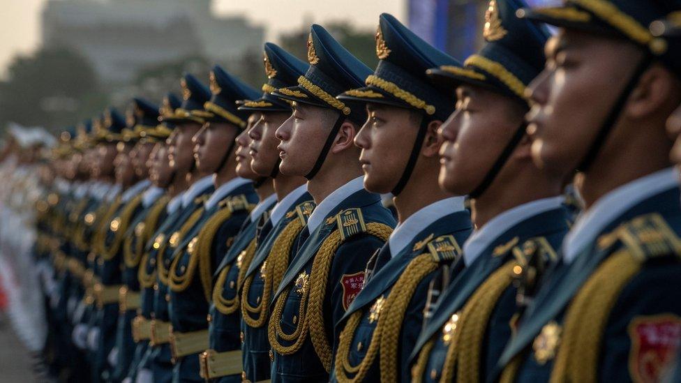 Soldiers in the People's Liberation Army stand to attention