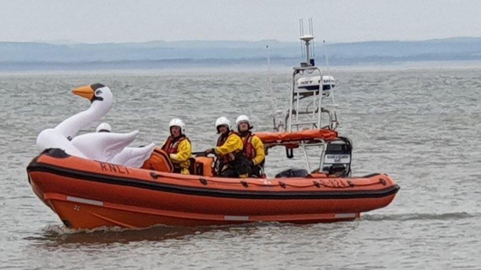 RNLI rescue team with the girls and float