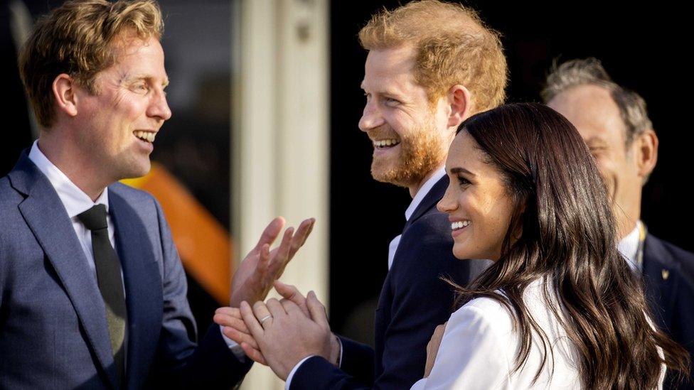 Prince Harry, Duke of Sussex (C) and his wife, Meghan, Duchess of Sussex (R) arrive on the Yellow Carpet before the start of the Invictus Games in The Hague