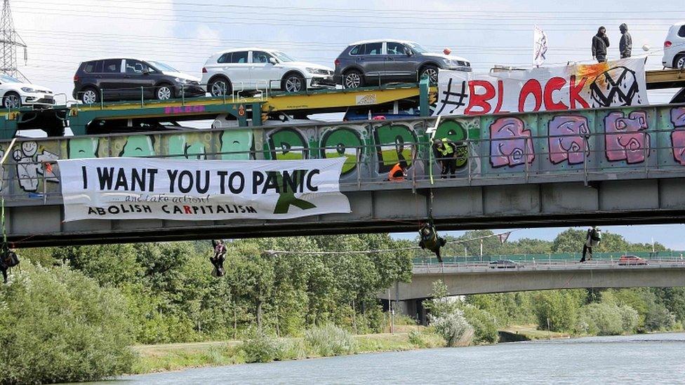 Environmentalists block railway tracks and stop a train loaded with new Volkswagen cars that has left the Volkswagen plant in Wolfsburg, northern Germany, on August 13, 2019