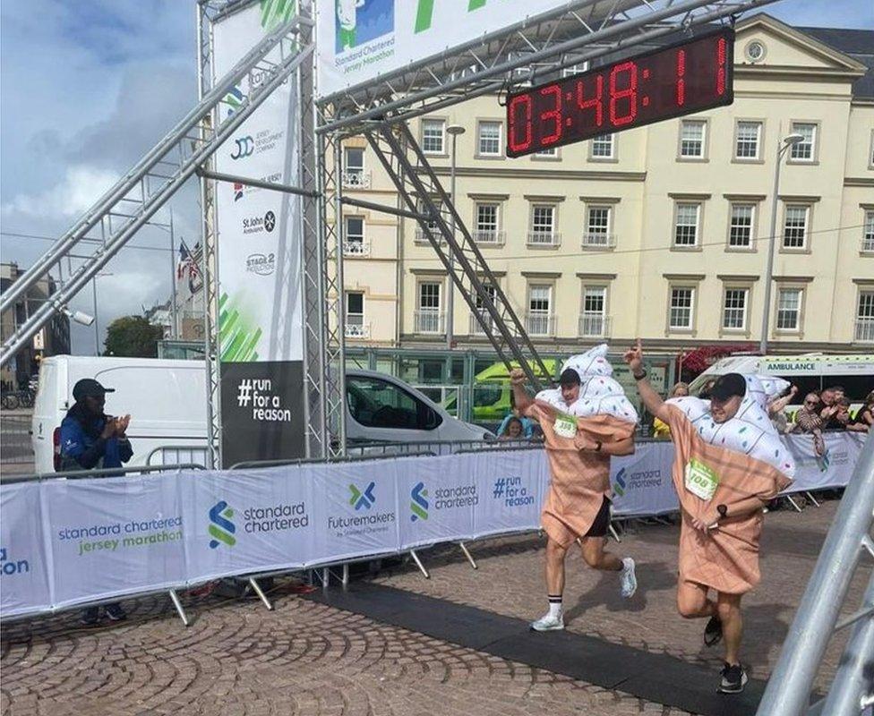 The pair crossing the finish line