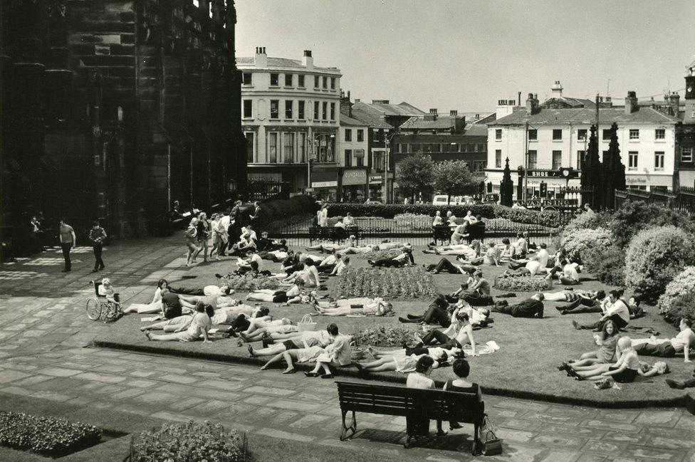 People sunbathing outside St Luke's Church