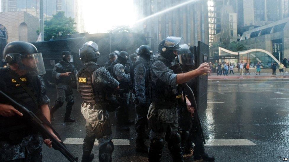 Riot police spray water against anti-government protesters occupying Paulista Avenue in central Sao Paulo, on March 18, 2016.