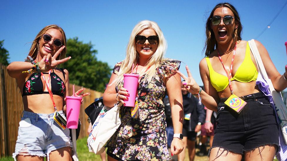 Three music fans after arriving at Glastonbury on Wednesday