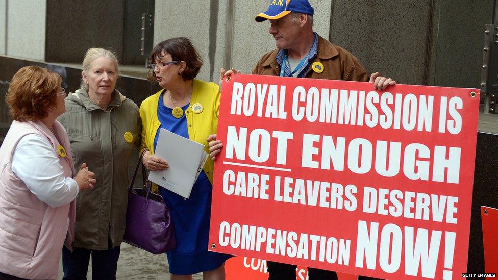 Members of CLAN, a network for people who grew up in Australia's orphanages, children's homes and in foster care stand with placards outside the Royal Commission into Institutional Responses to Child Sexual Abuse in Sydney on September 16, 2013.