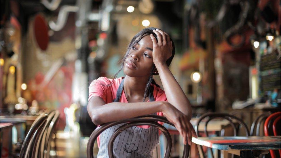 A waitress looking sad