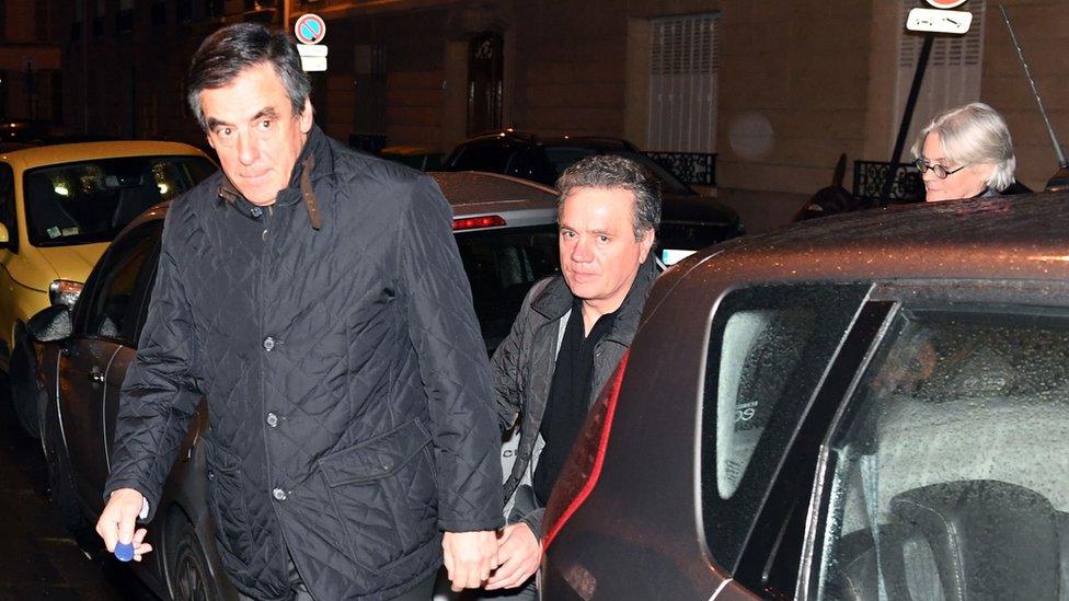 French right wing candidate for the upcoming presidential election Francois Fillon (L) and his wife Penelope Fillon (R) arrive at their home in the 7th arrondissement in Paris on late January 30, 2017