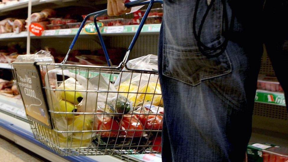 A man carrying a shopping basket