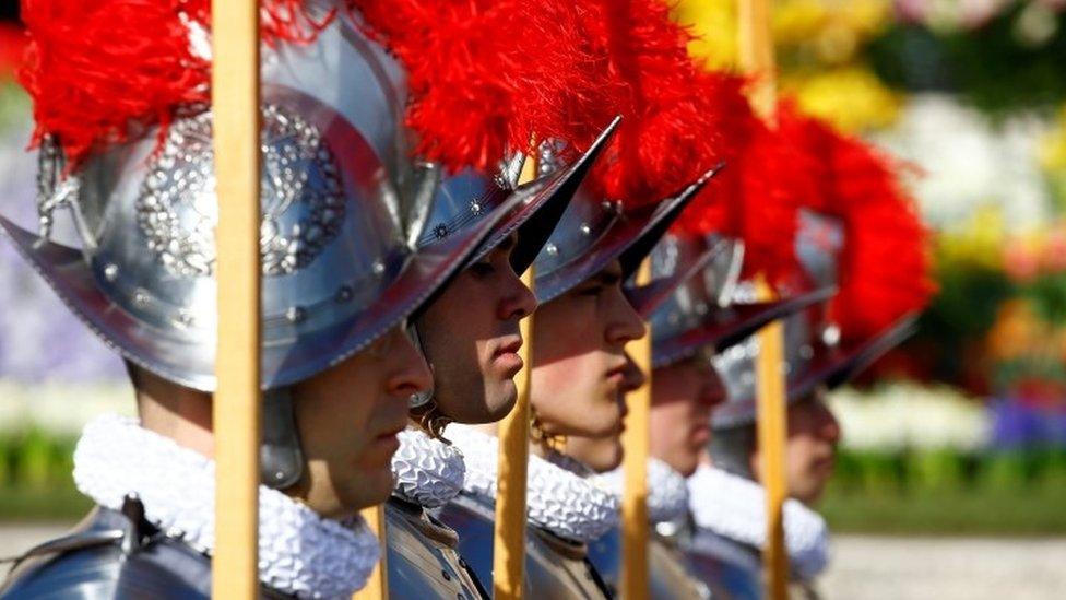 Swiss Guards stand in front of the St. Peter"s Basilica before the Easter Mass at St. Peter"s Square at the Vatican April 1, 2018