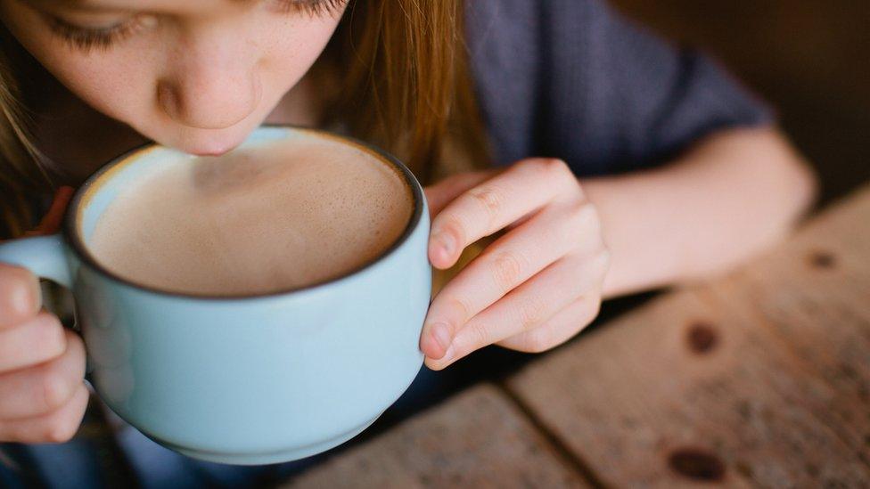 Child drinking from a mug