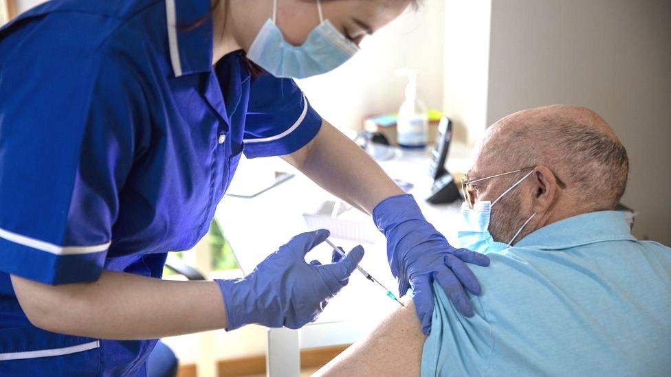 Older man being vaccinated