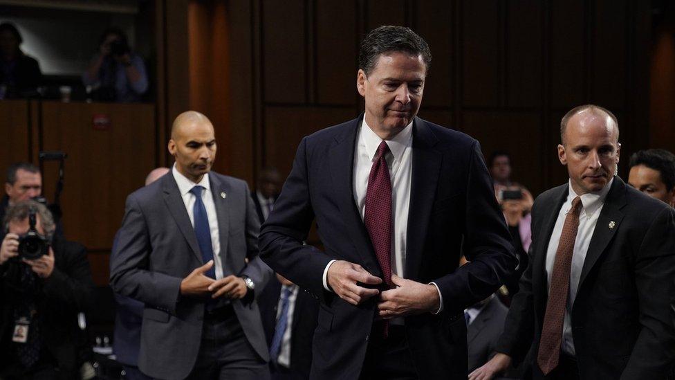 James Comey gets up to leave after giving testimony to the Senate Intelligence Committee