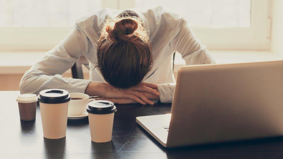 Woman resting her head on her hands