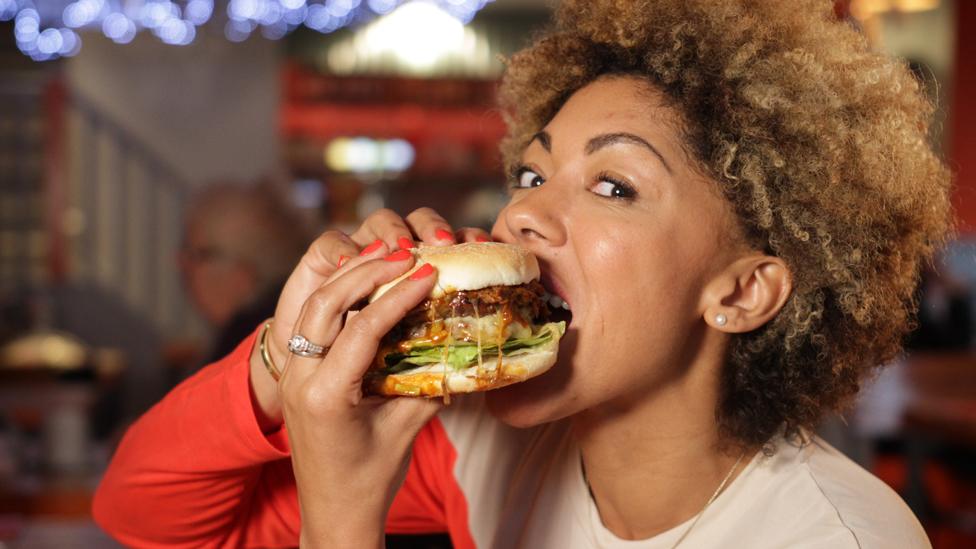 Zoe Williams eating a burger