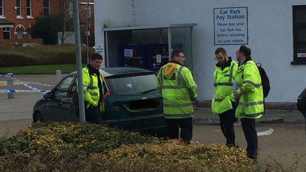 Police near the car at the scene