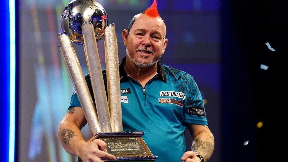 Darts player Peter Wright with trophy