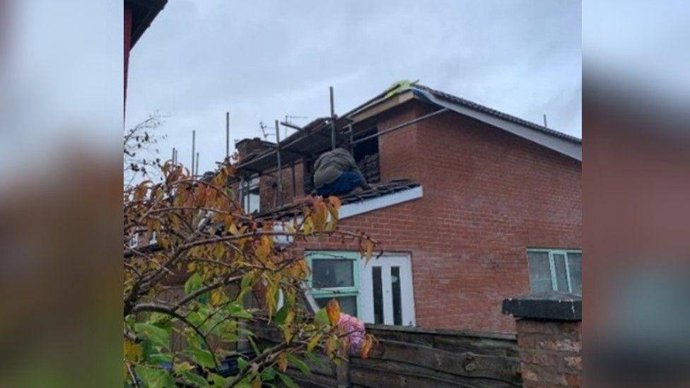 Abdul Rehman pictured working on the roof at his propert