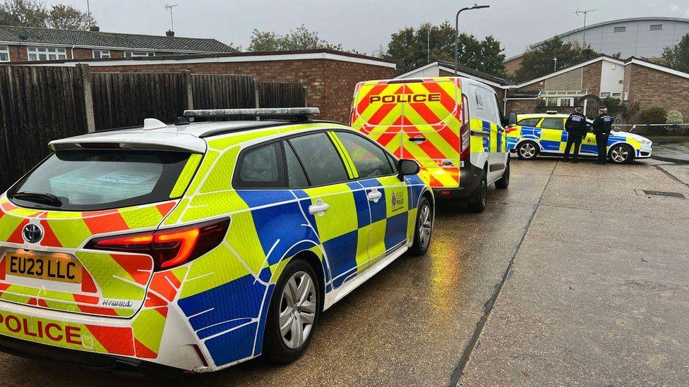 Police cars parked outside the property