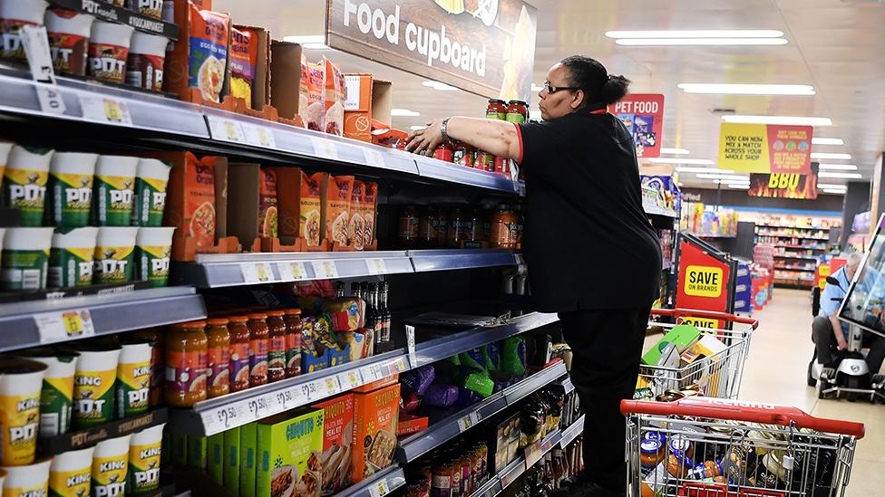 A supermarket staff loads shelves at a supermarket in London, Britain, 27 June 2023.