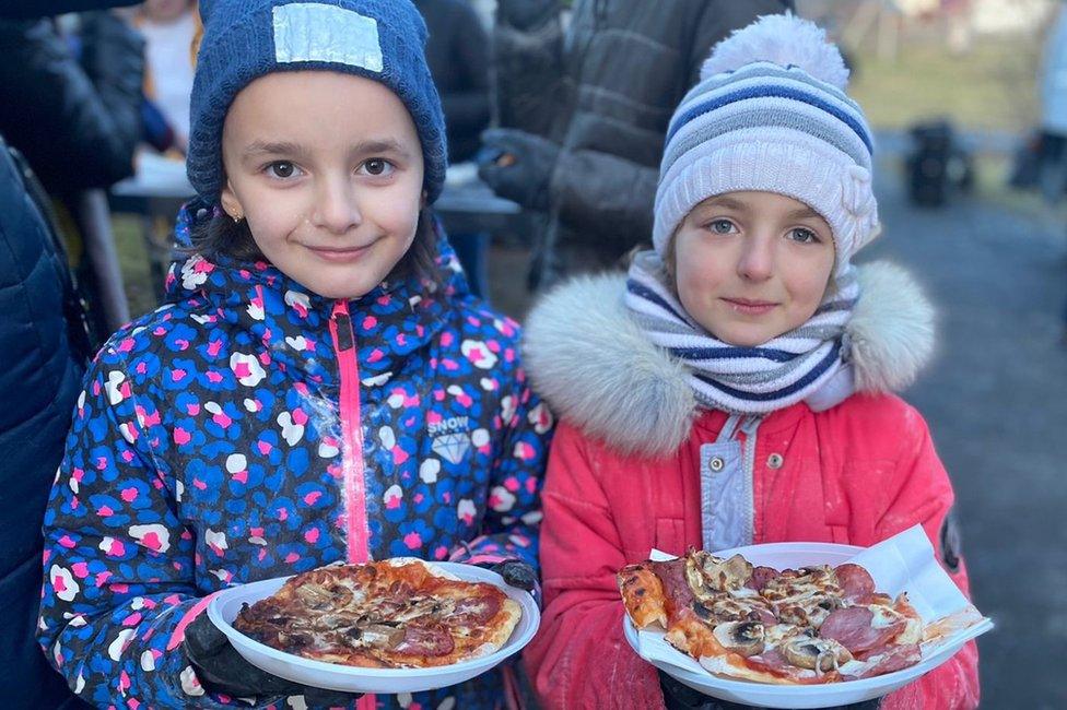 Two young girls with pizza