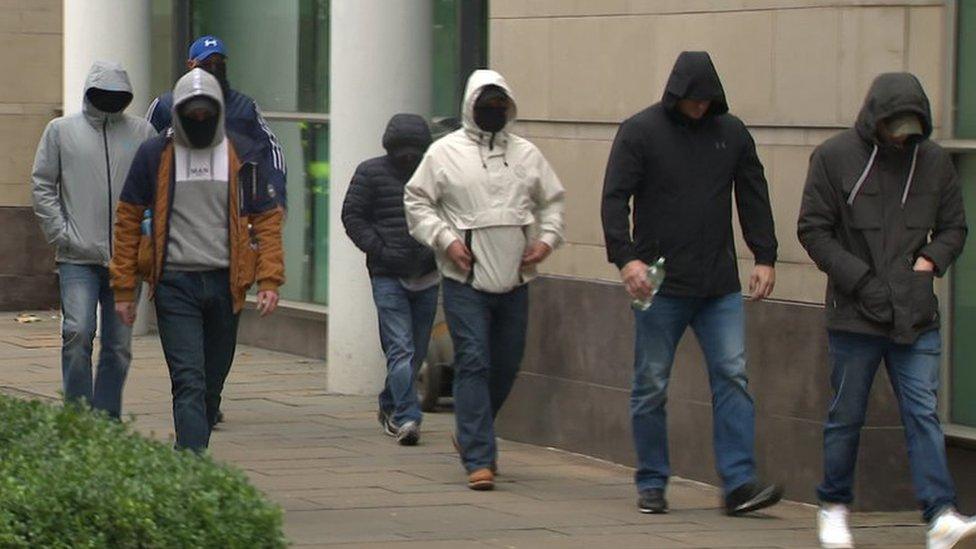 Masked men outside Laganside Courts