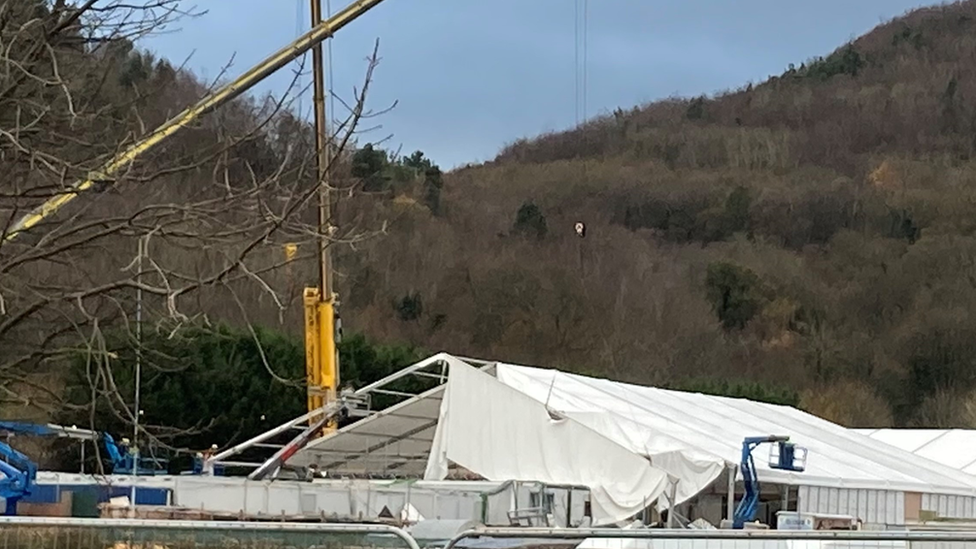 Cranes work to repair giant marquee