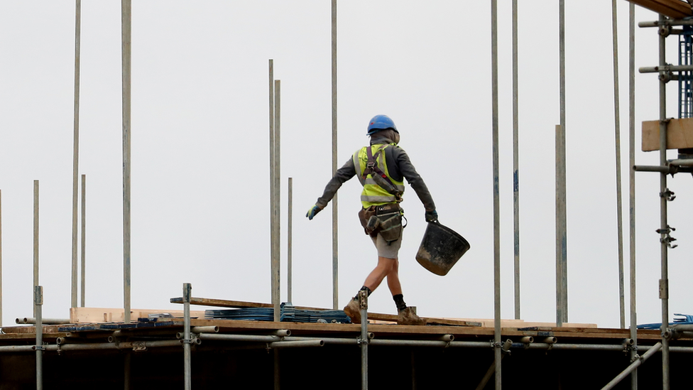 A builder on a roof