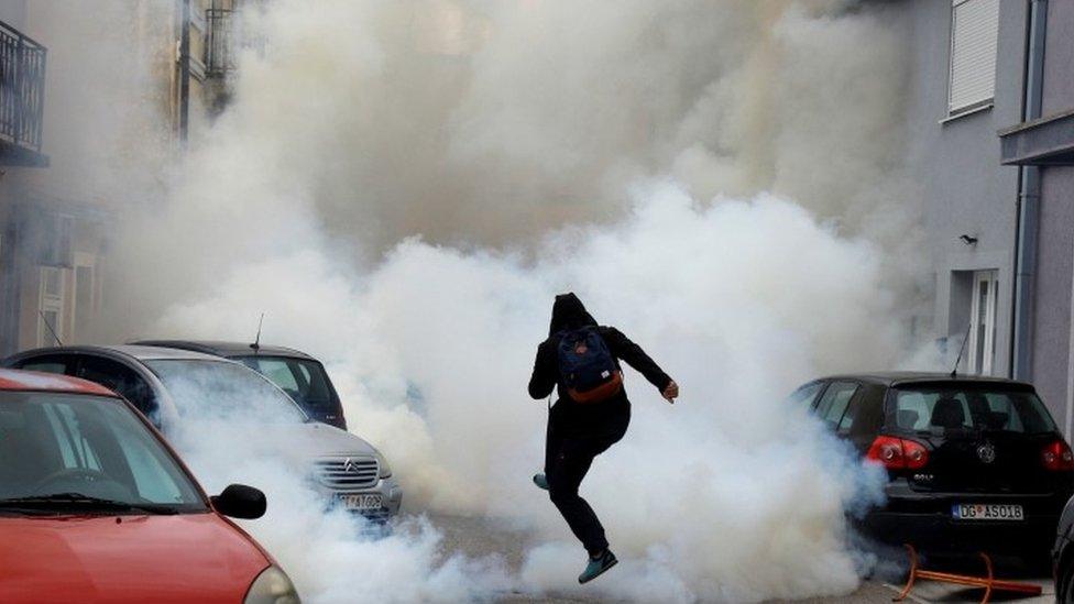 A protester is enveloped in tear gas in Montenegro