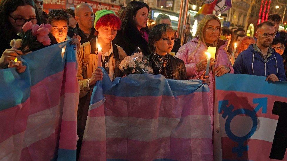 Members of the public attend a candle-lit vigil at the Spire on O'Connell Street in Dublin