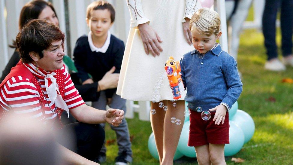 Prince George plays with a bubble gun at Government House