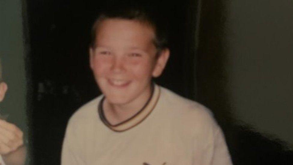 Jack Barnes when he was a young boy, pictured smiling and wearing a white t-shirt. 