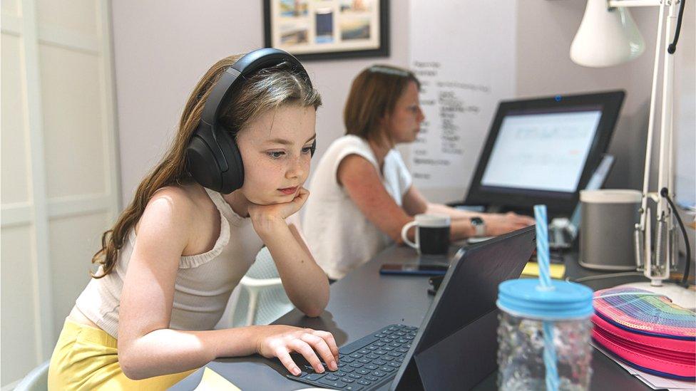 girl on laptop with mum working in room