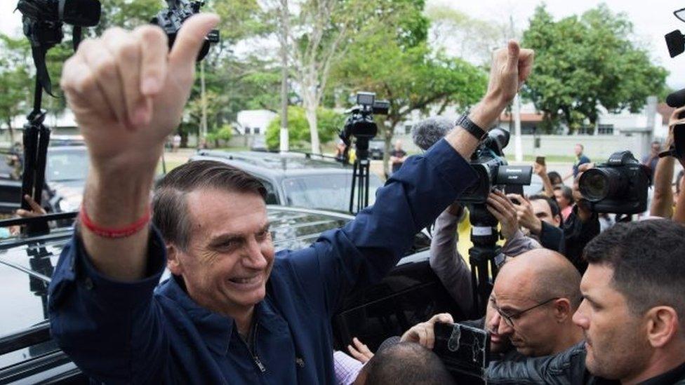 Jair Bolsonaro gives his thumbs up after casting his vote at Villa Militar,