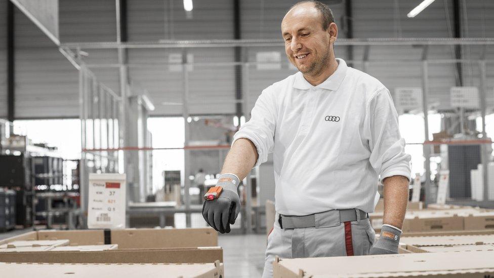 Audi worker scanning boxes