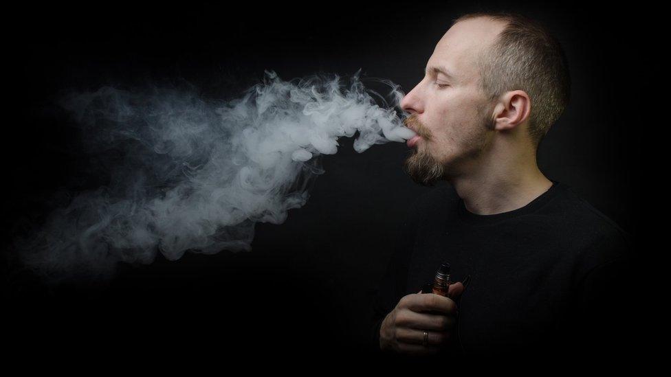 Person using e-cigarette