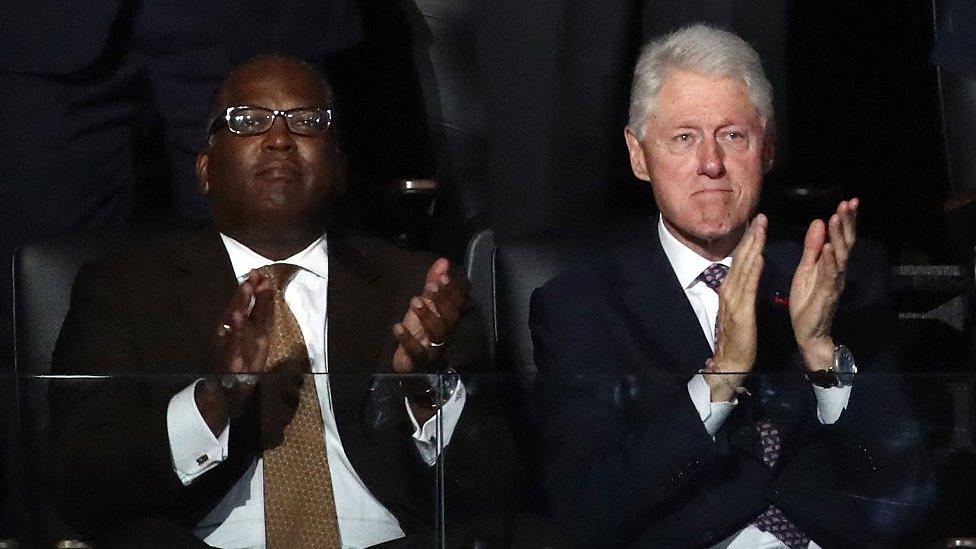 Former U.S. President Bill Clinton (right) claps during first lady Michelle Obama's speech on the first day of the Democratic National Convention