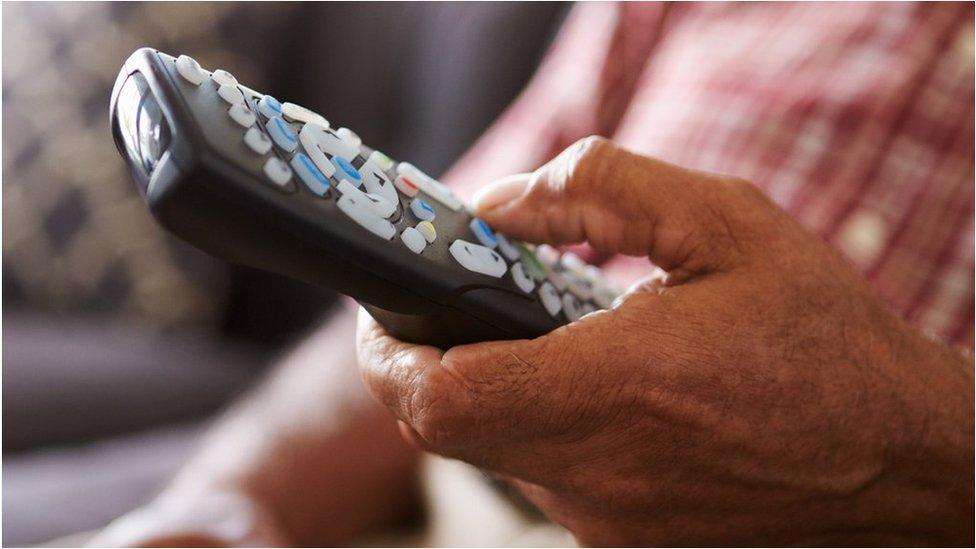 Person holding remote control