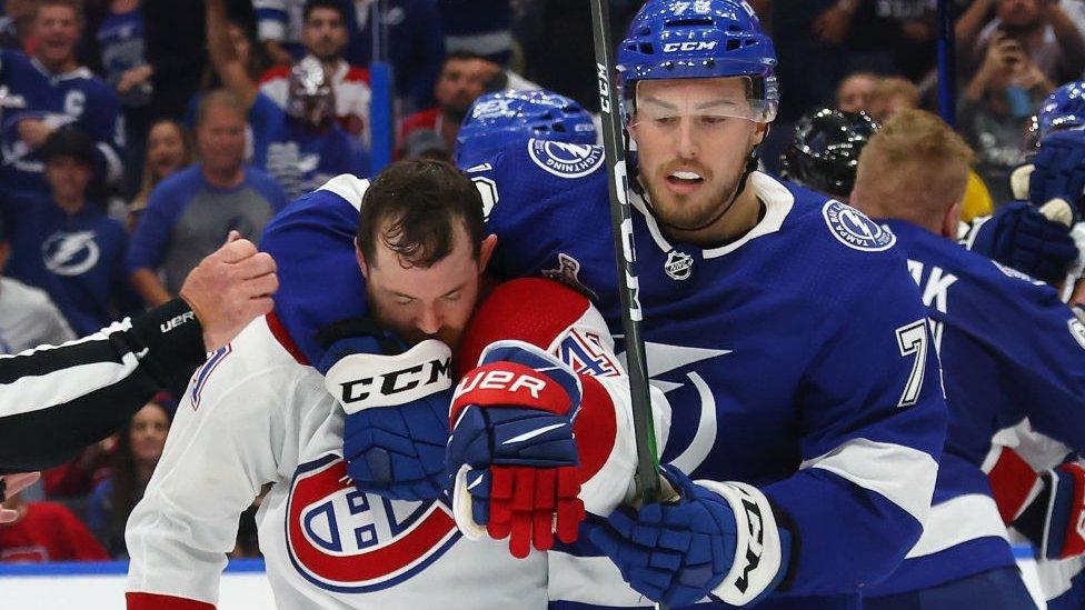 Ross Colton of the Tampa Bay Lightning holds onto Paul Byron of the Montreal Canadiens during Game One of the Stanley Cup Finals