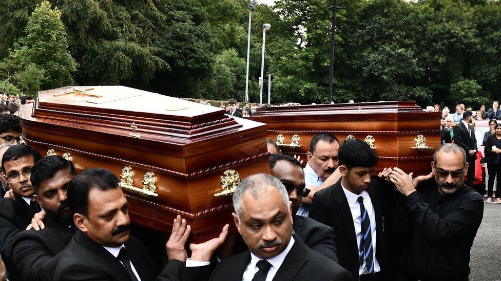 The coffins of Pictures of Reuven Simon and Joseph Sebastian are carried into St Mary's Church by relatives and friends