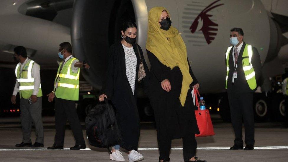 Travellers from Kabul disembark their plane in Doha, 9 September 2021