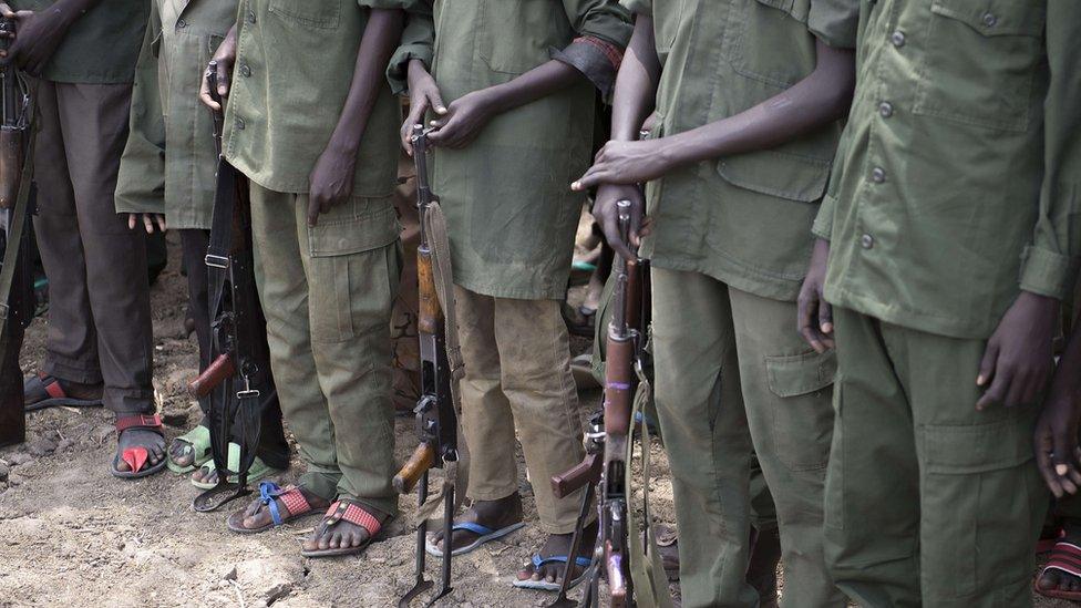 A file photo taken on February 10, 2015 shows young boys, child soldiers, preparing to lay down their arms at a ceremony of disarmament, demobilisation and reintegration in Pibor overseen by Unicef and partners.