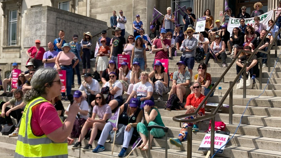 Chloe Wallace addresses a crowd of strike supporters in Leeds