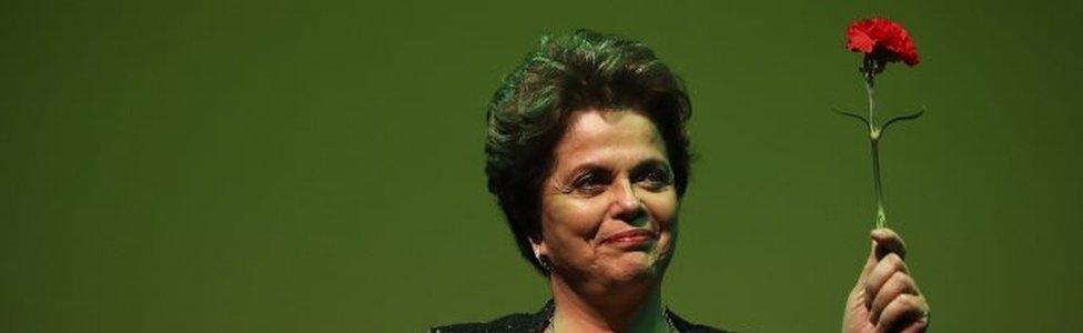 Former president of Brazil Dilma Rousseff holds a red carnation as she attends the conference "Neoliberalism, inequality, democracy under attack" at Trindade Theater, in Lisbon, Portugal, 15 March 2017.