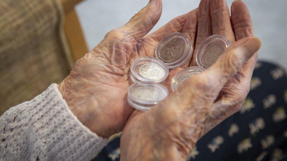 Peggy Terry holding five shillings