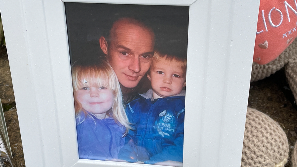 Vigil in Bristol showing a family photograph of stabbing victim Max Dixon